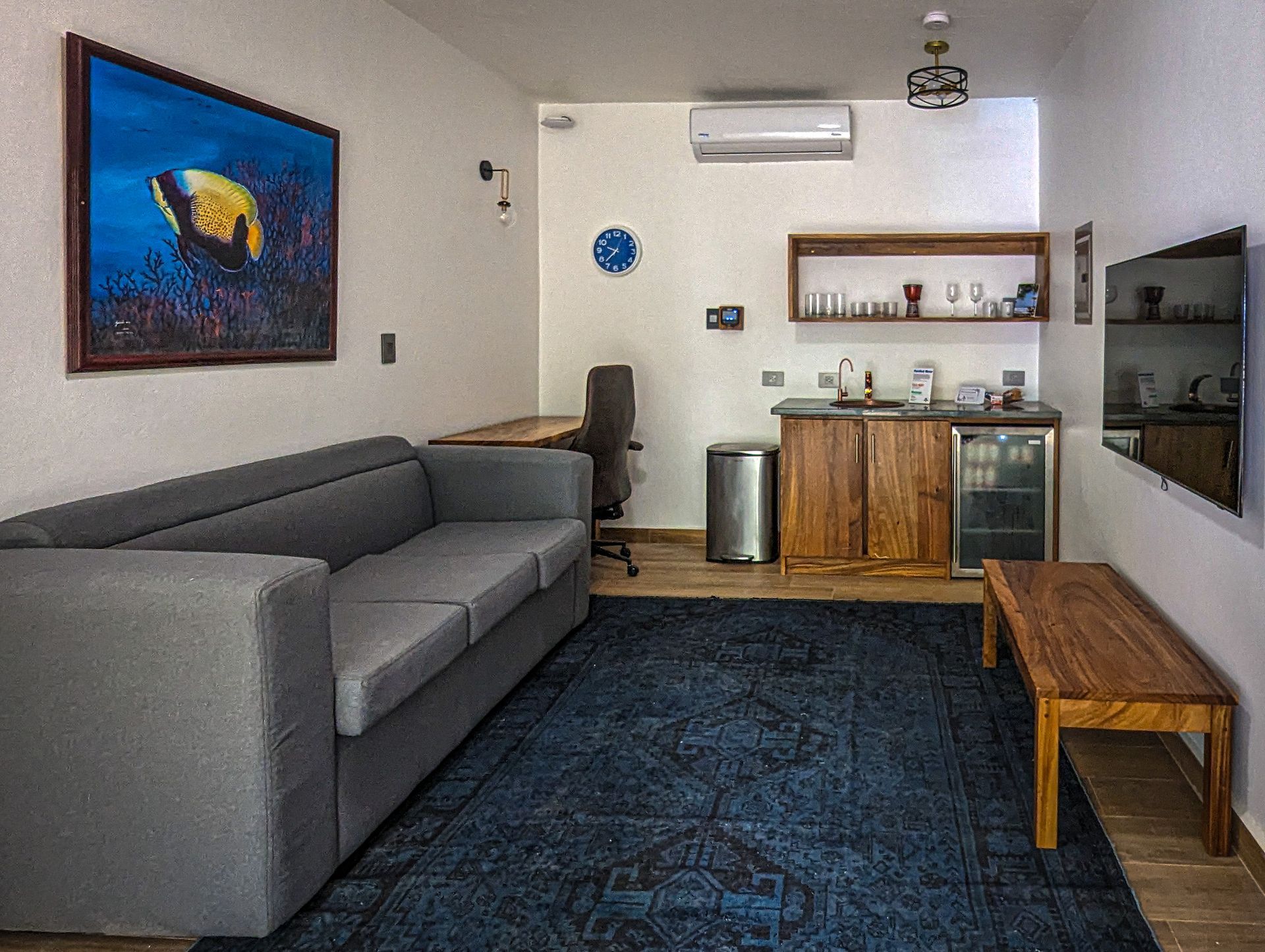 A living room with a couch , table and television.
