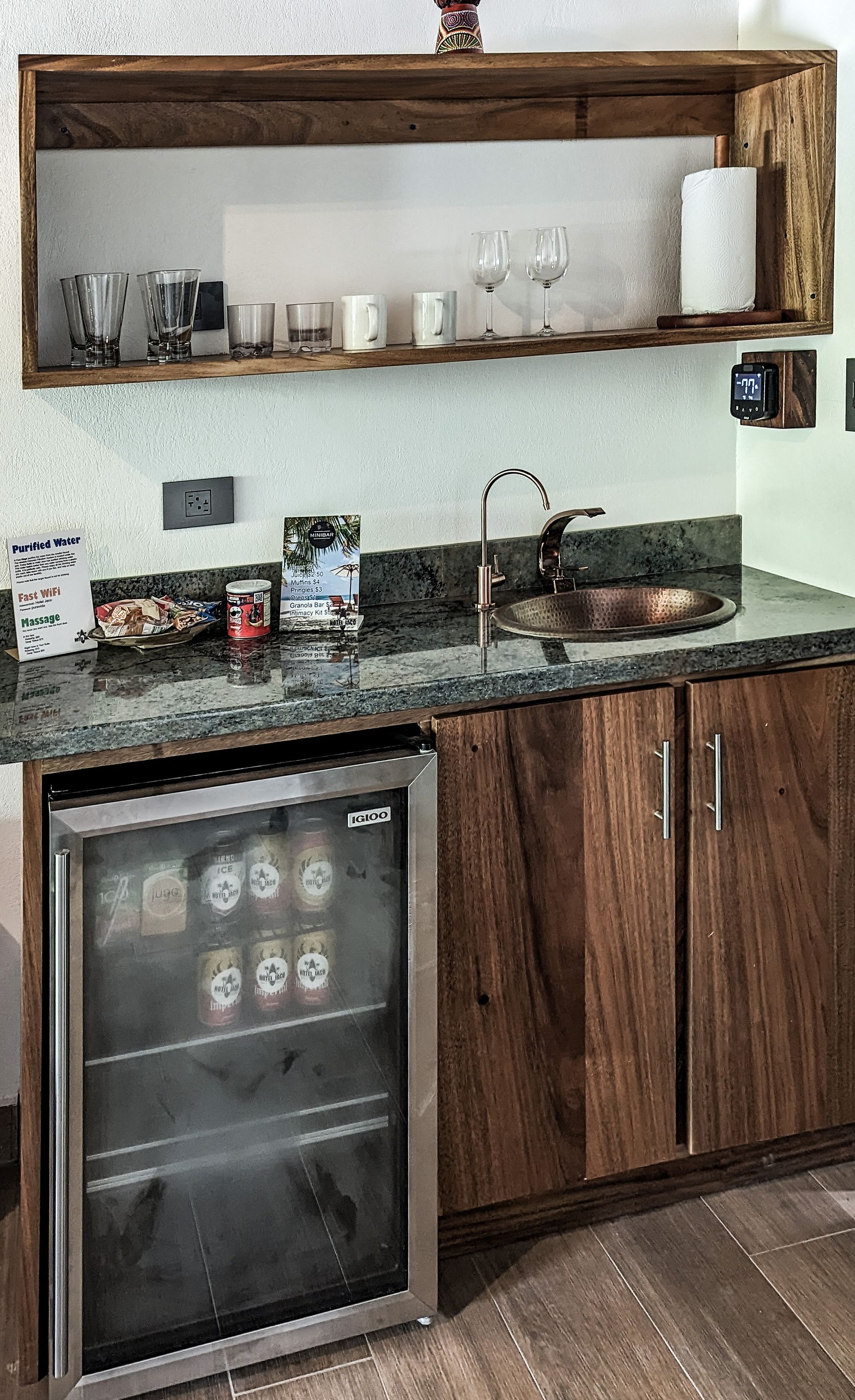 A kitchen with wooden cabinets and a glass door refrigerator.