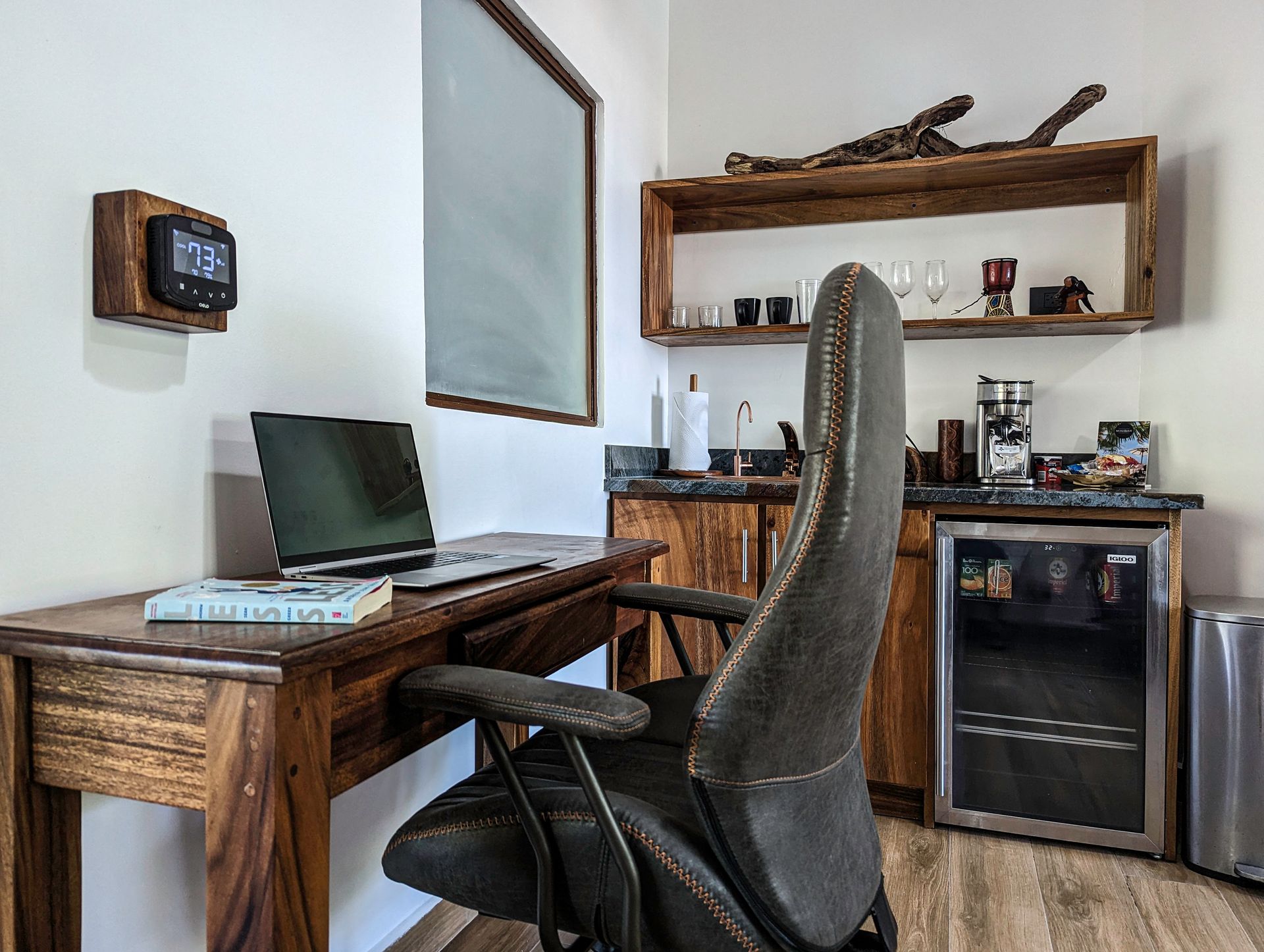 A chair is sitting at a desk with a laptop on it.