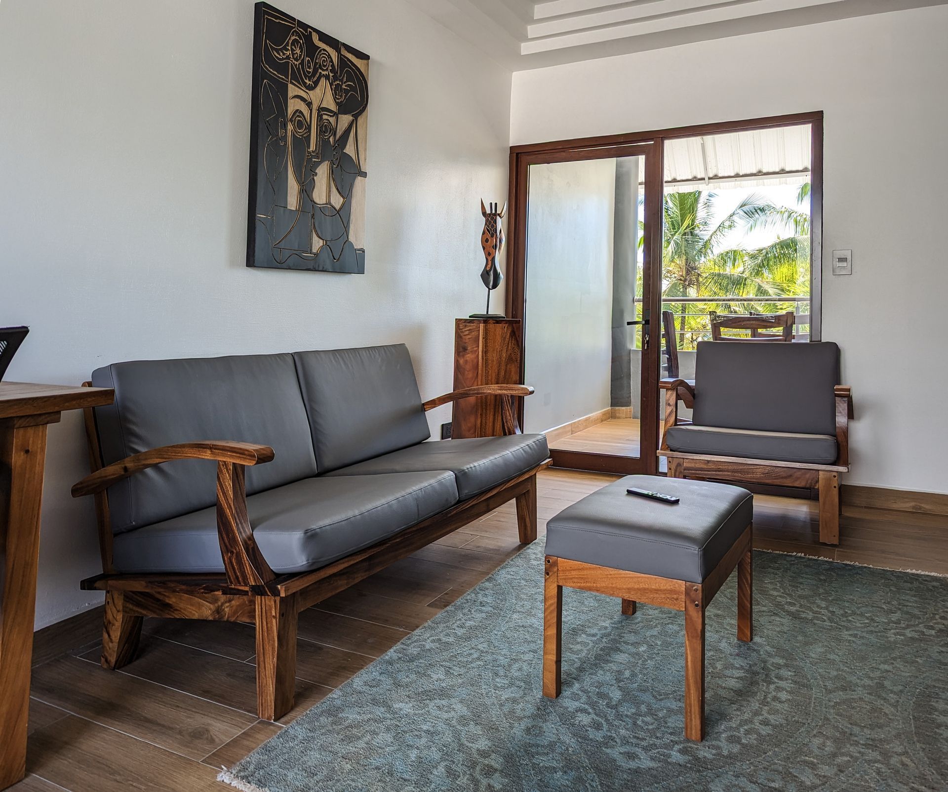 A living room with a couch and chairs and a sliding glass door