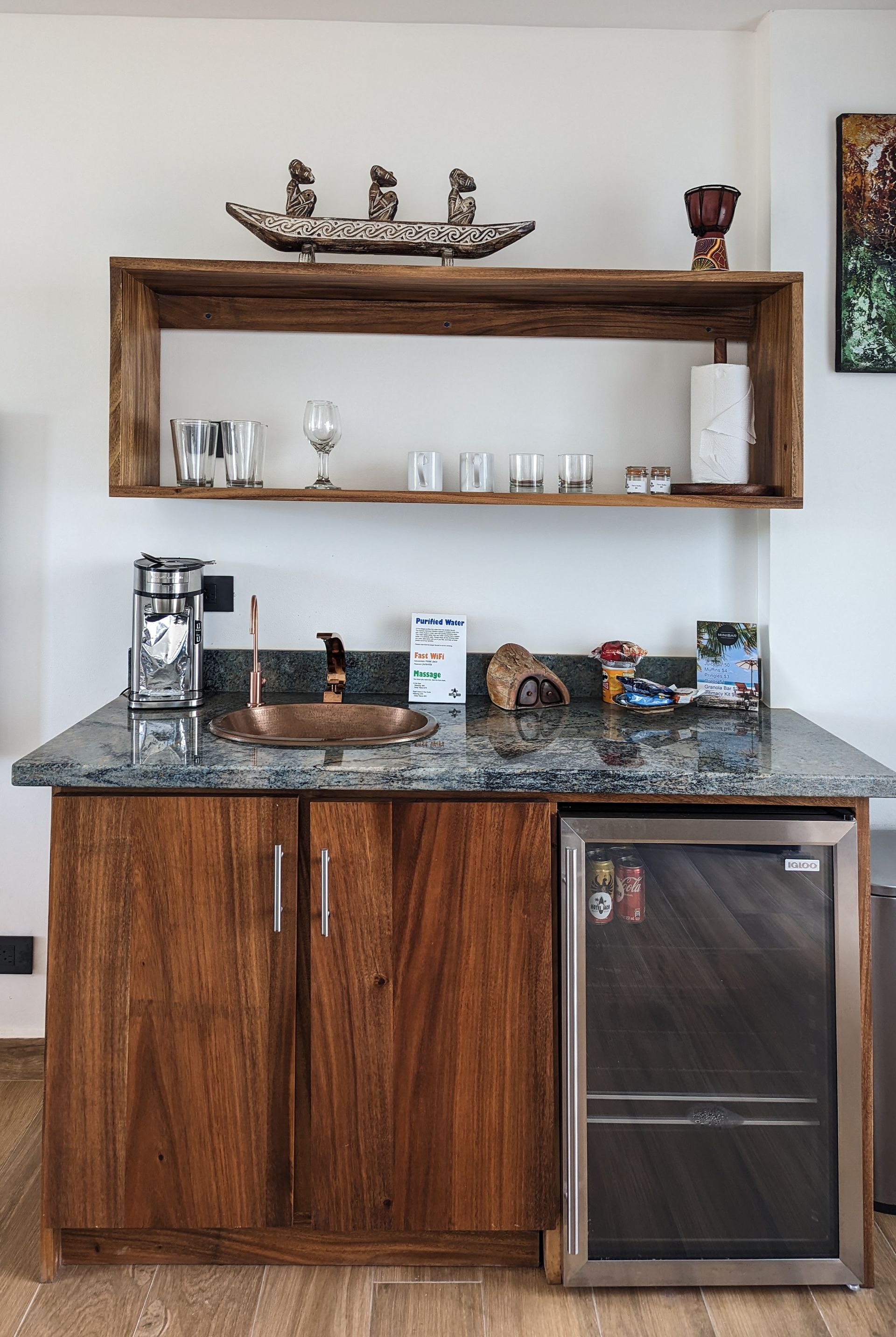 A kitchen with wooden cabinets and a stainless steel refrigerator.