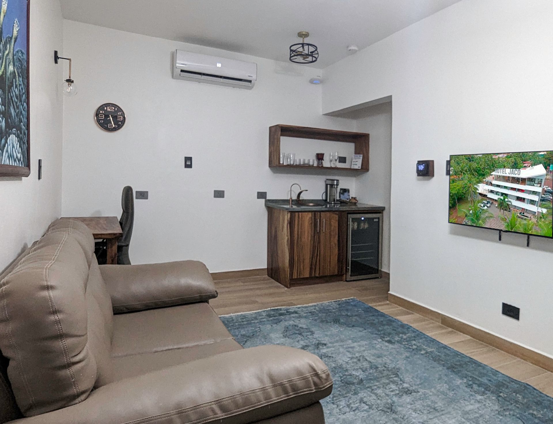 A living room with a couch , chair and television.