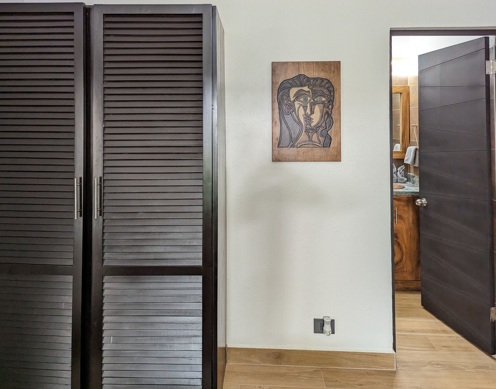 A room with a picture on the wall and a door