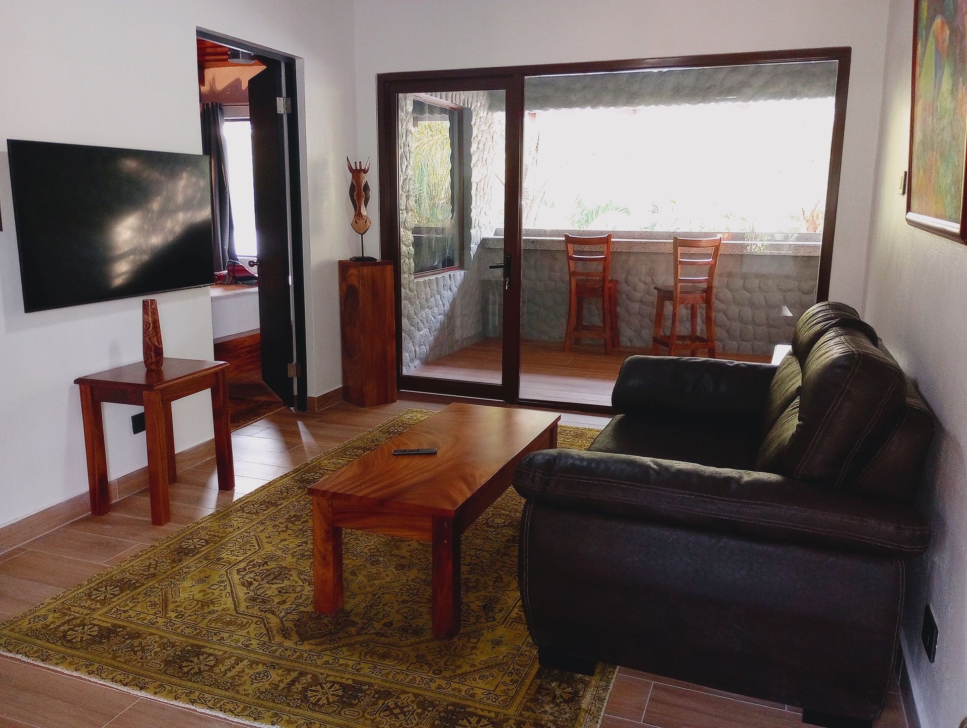 A living room with a couch and a flat screen tv