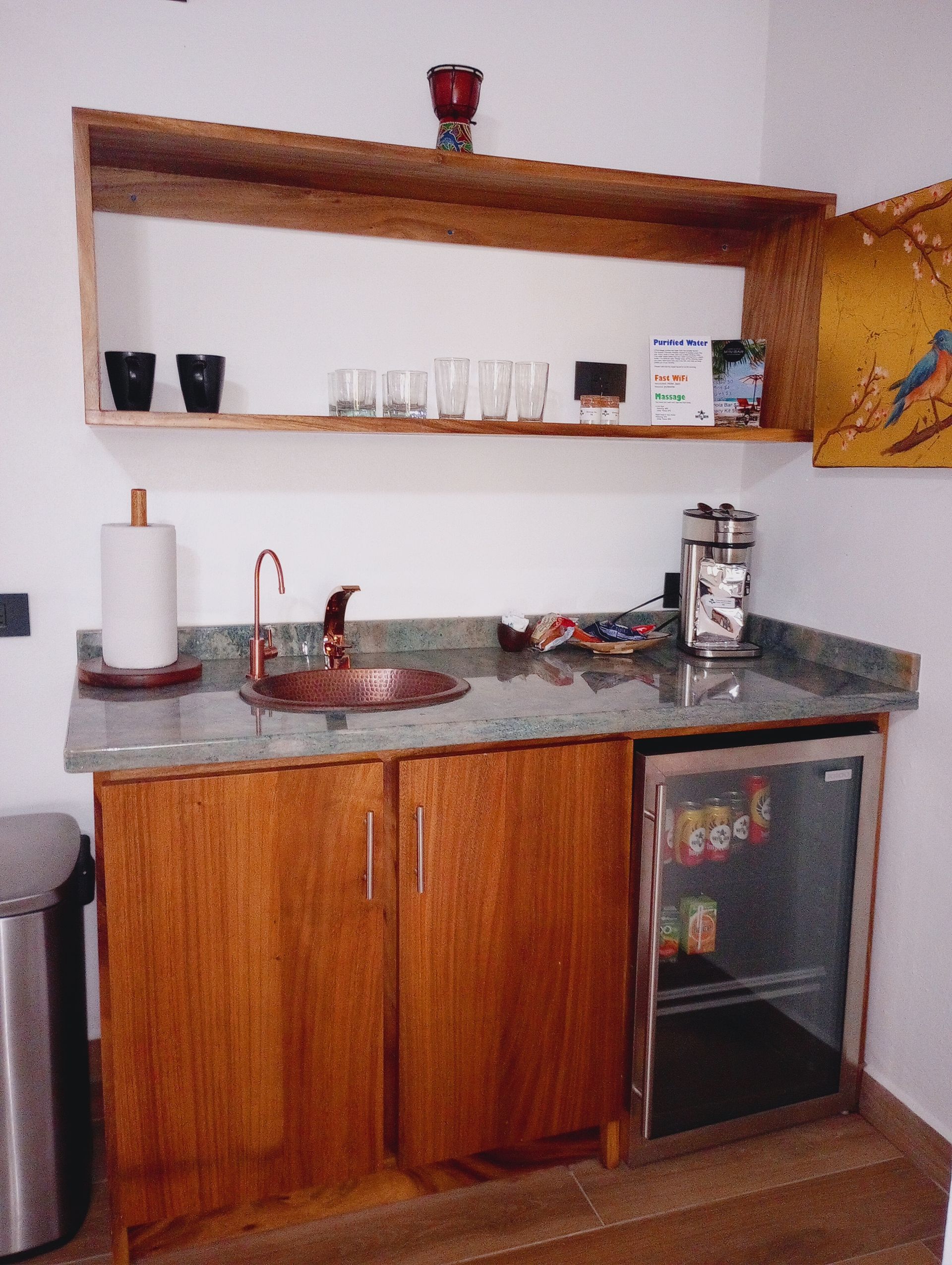 A small kitchen with a sink and a refrigerator