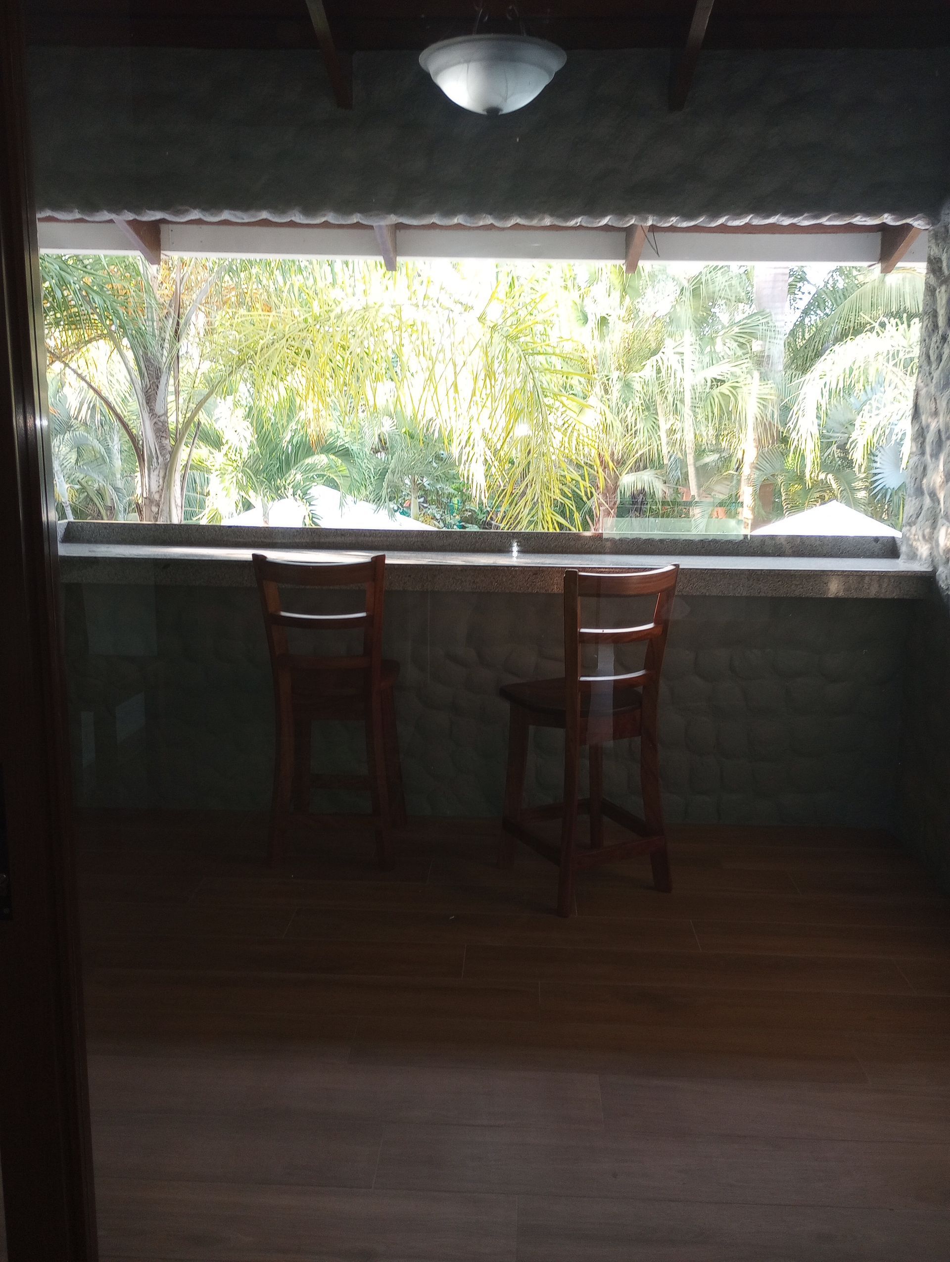 A room with two chairs and a large window