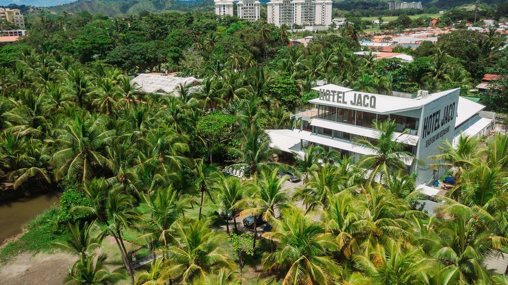 An aerial view of a hotel surrounded by palm trees.