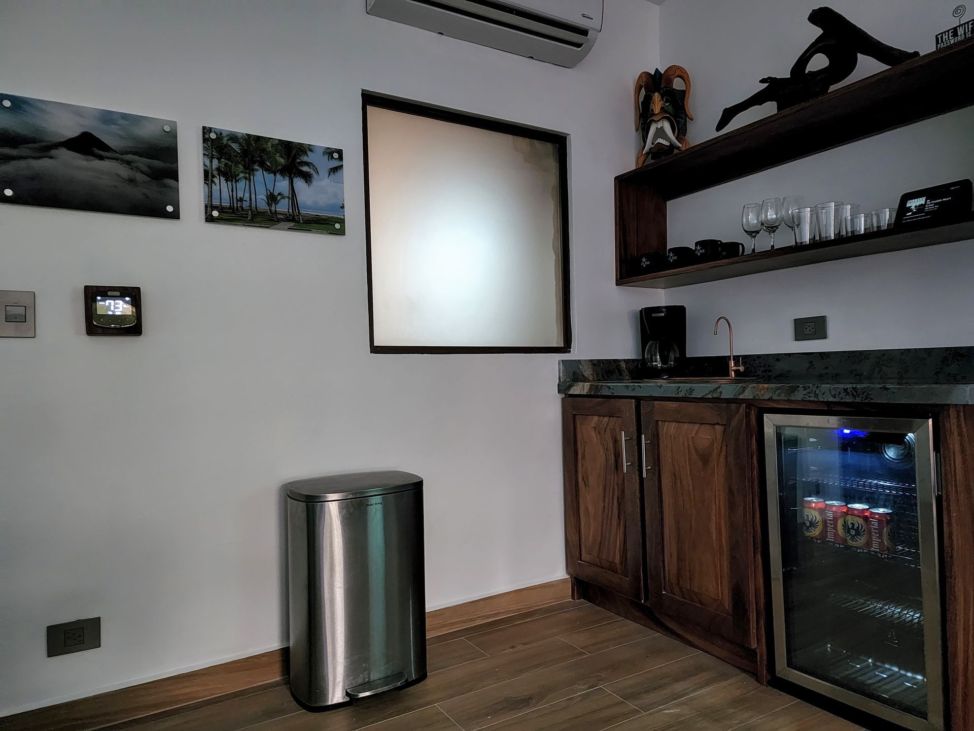 A kitchen with a fridge and a trash can