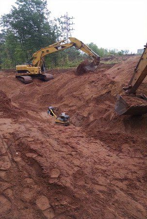 Excavation Contractor — Three Excavator at Work in Marquette, MI