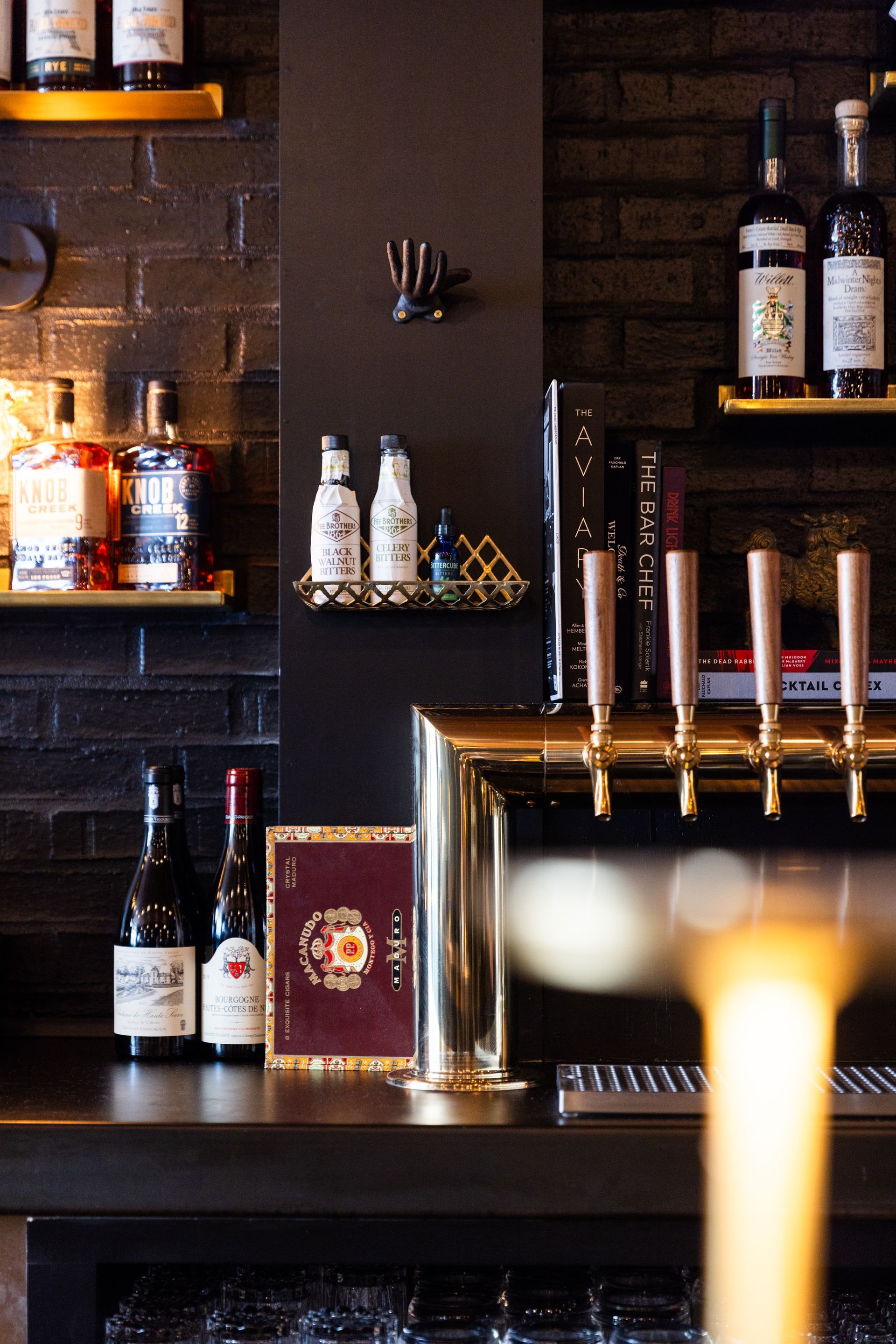 A bowl of ramen with chopsticks and a spoon on a table.
