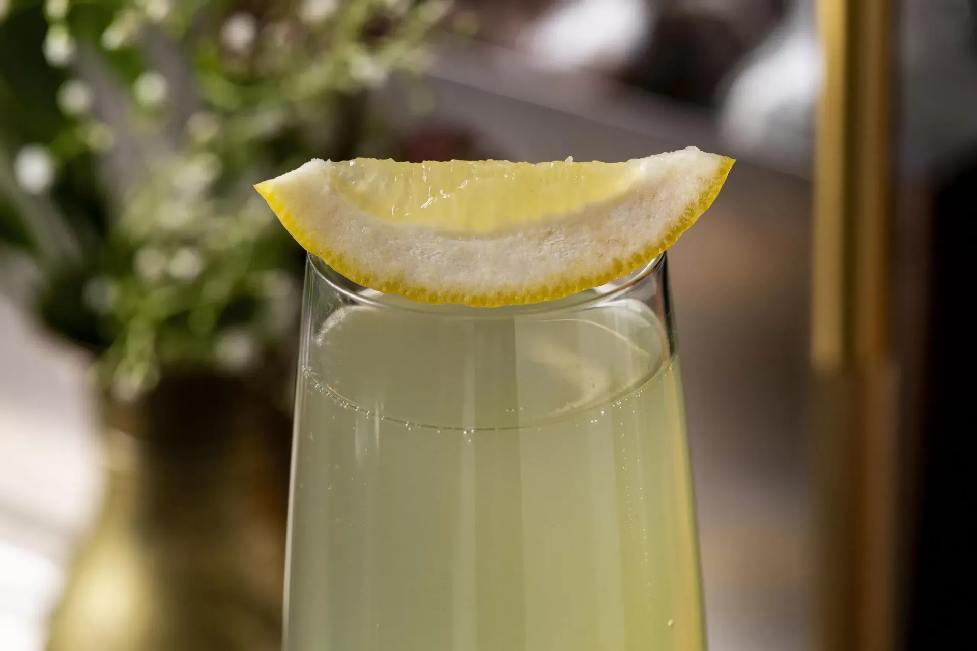 A bowl of ramen with chopsticks and a spoon on a table.