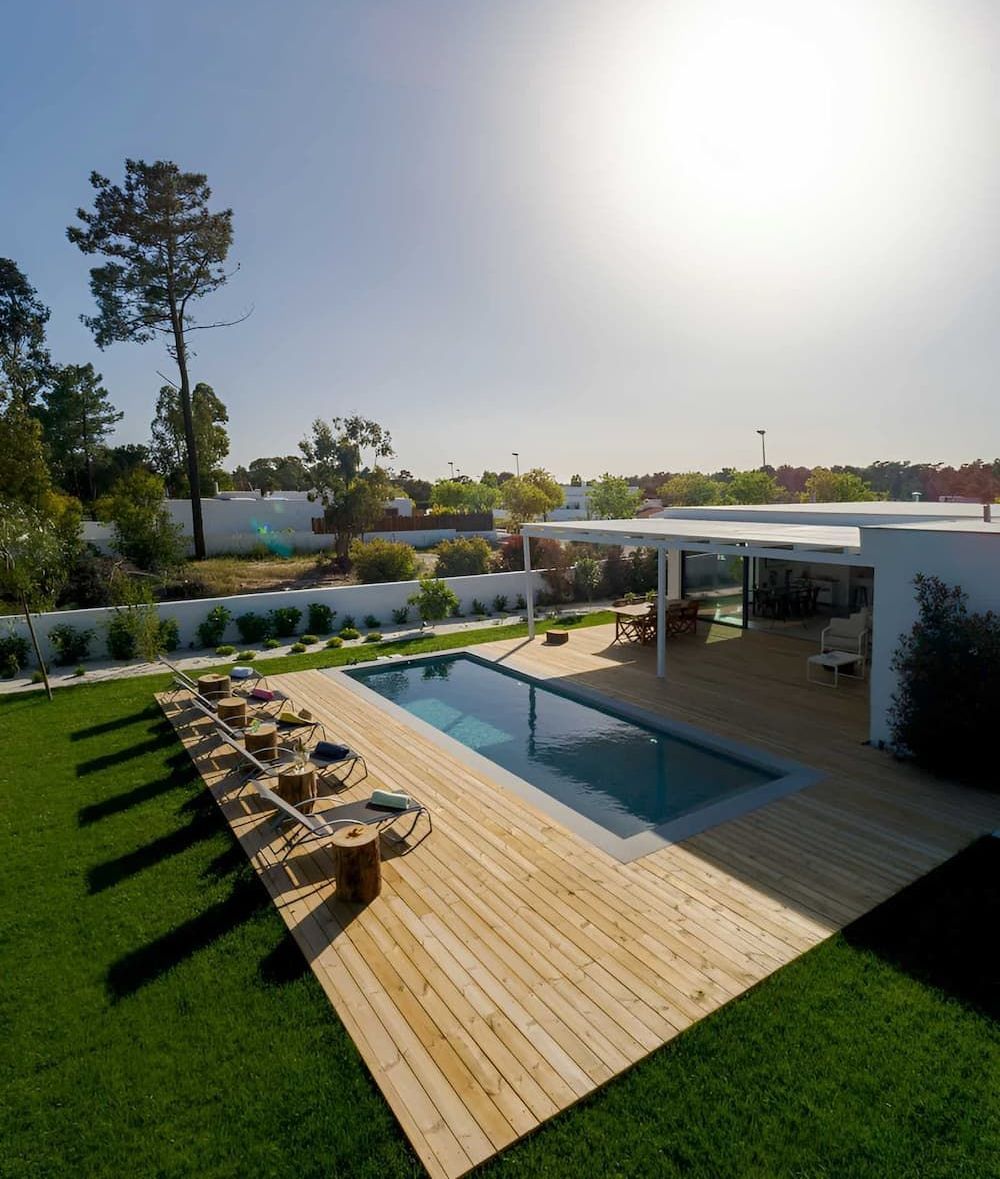 A Large Swimming Pool Is Surrounded by A Wooden Deck — MJ Watson Construction and Maintenance in Wagga Wagga, NSW
