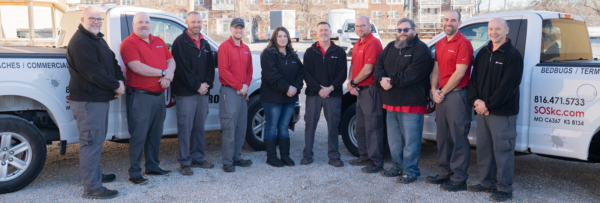 SOS Pest Control technicians and team of Kansas City are posing as a group by the building.