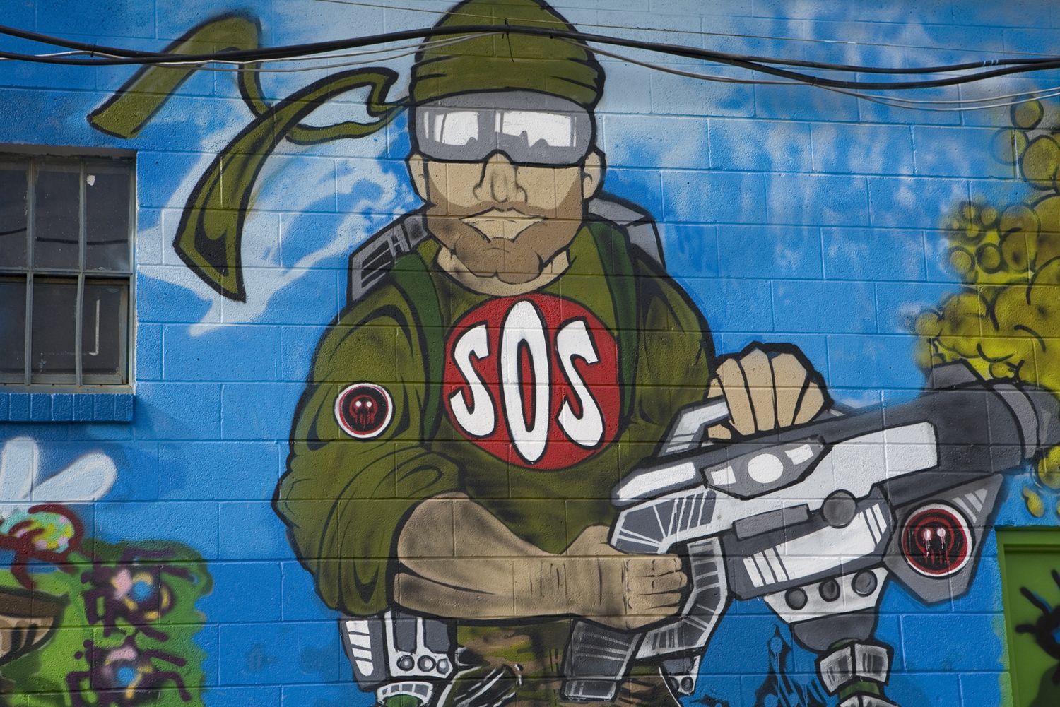 SOS pest control mural with a technician holding a ray gun