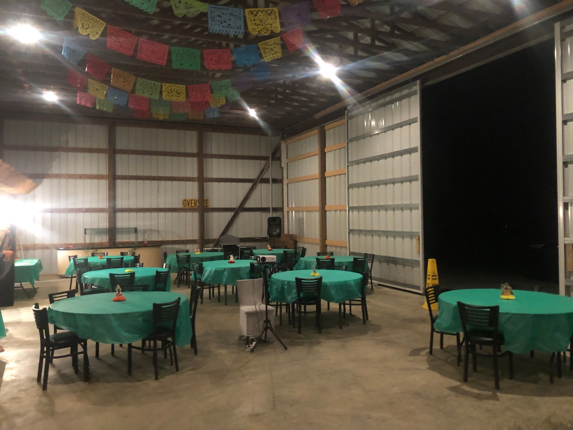a large room with tables and chairs set up for a party .