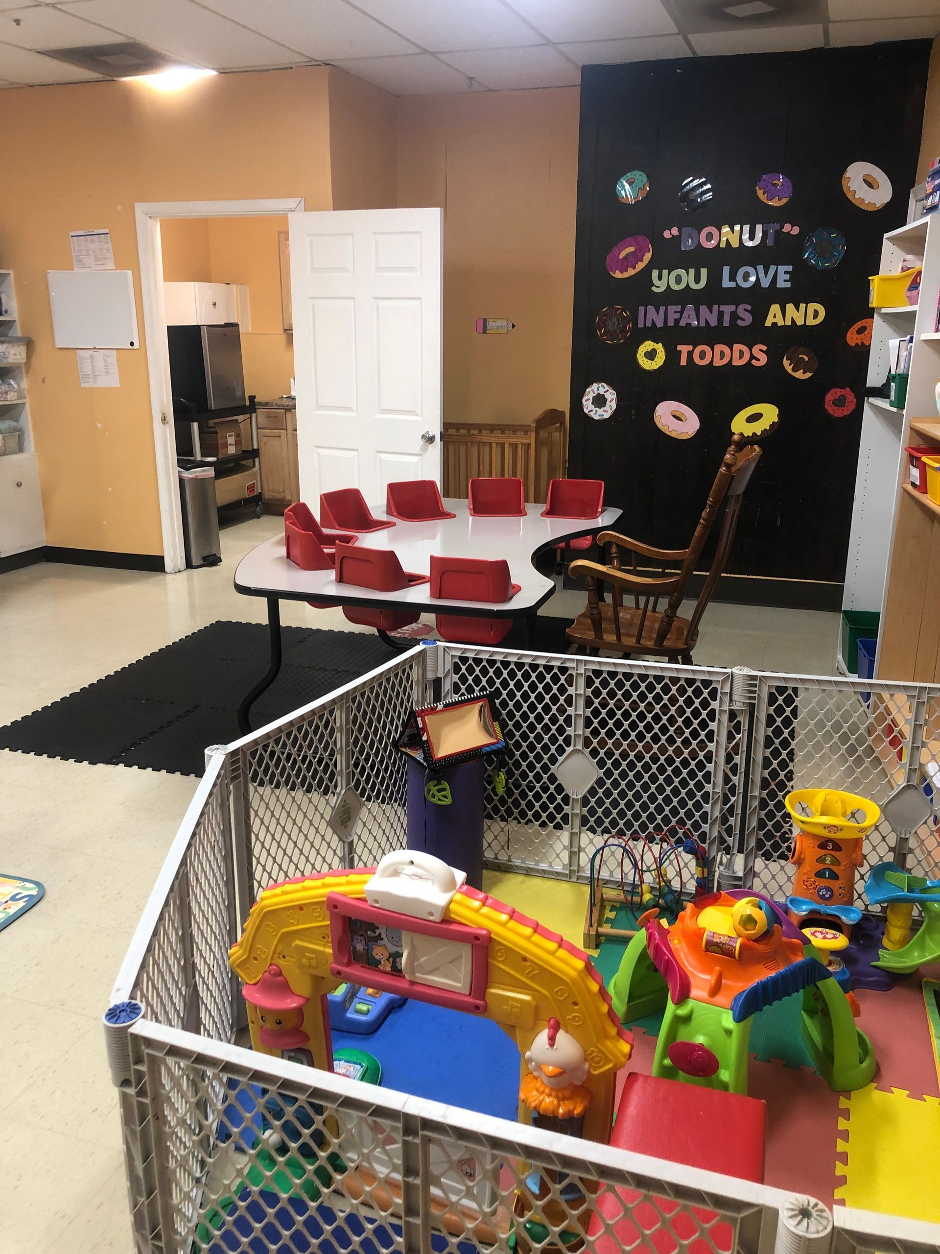 a room filled with lots of toys and a sign that says donuts you love infants and toddlers .