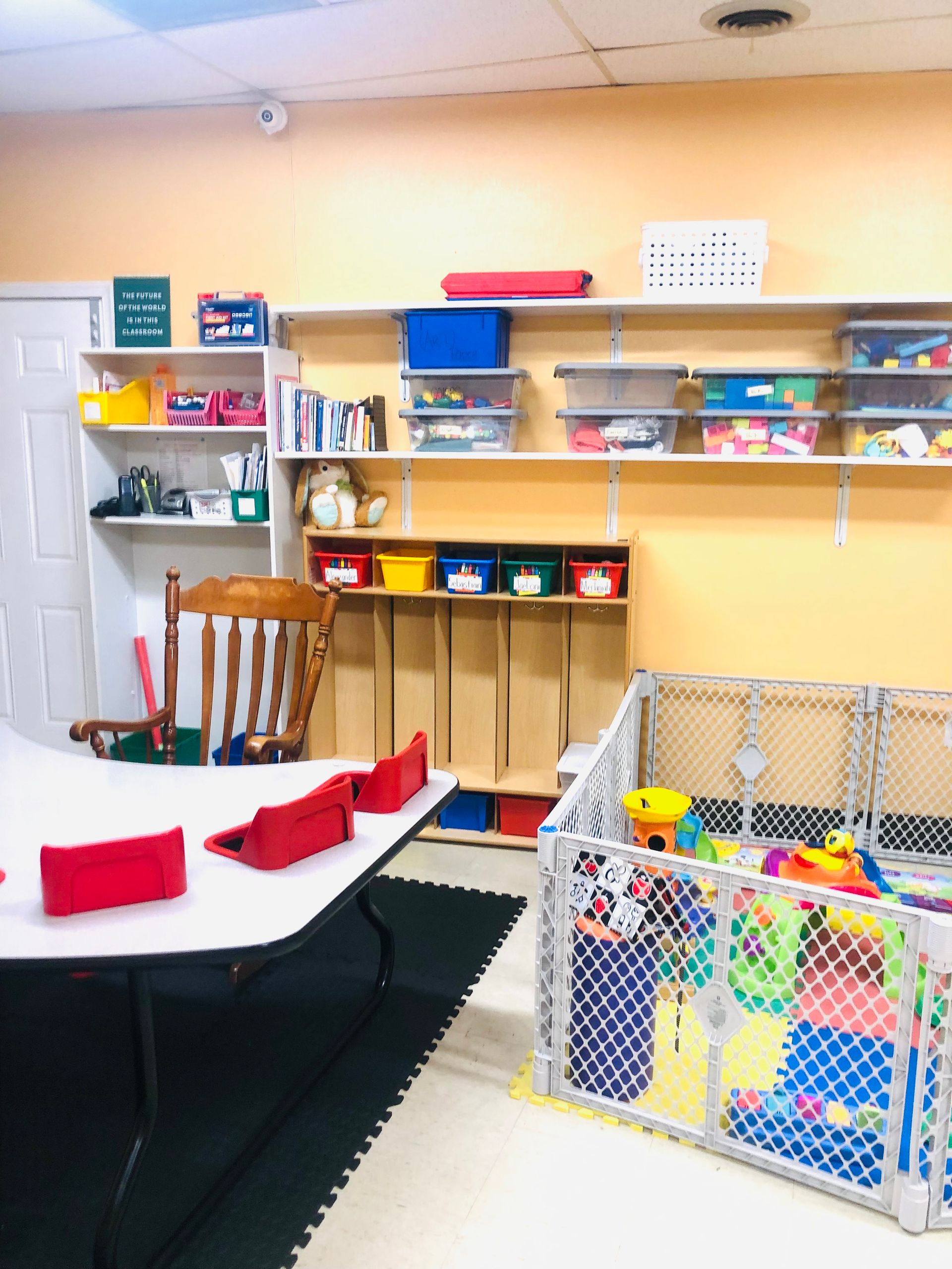 a room with a table and chairs and a play area