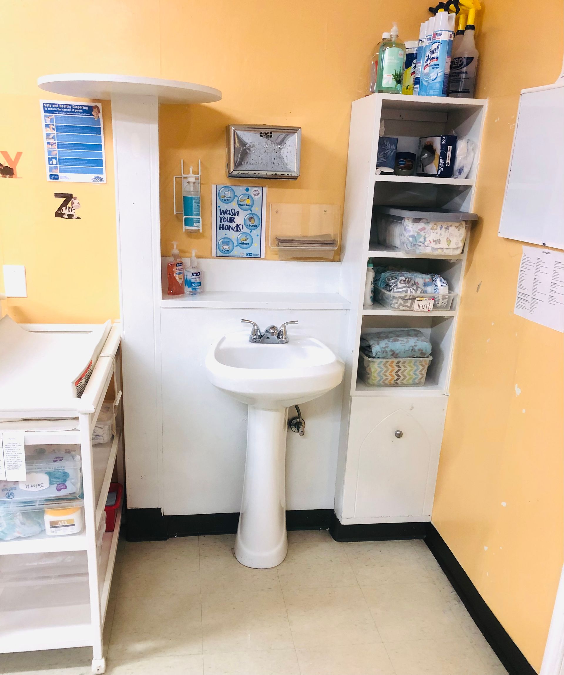 a bathroom with a sink and a changing table