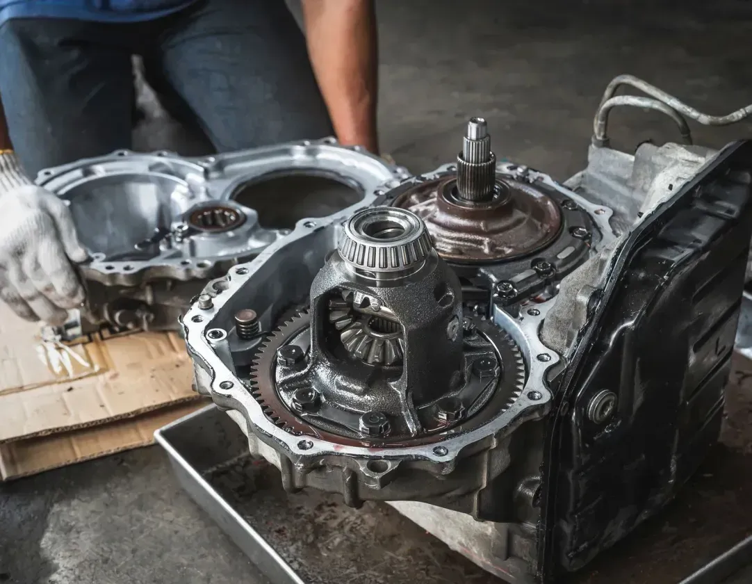 A man is working on a car engine in a garage.