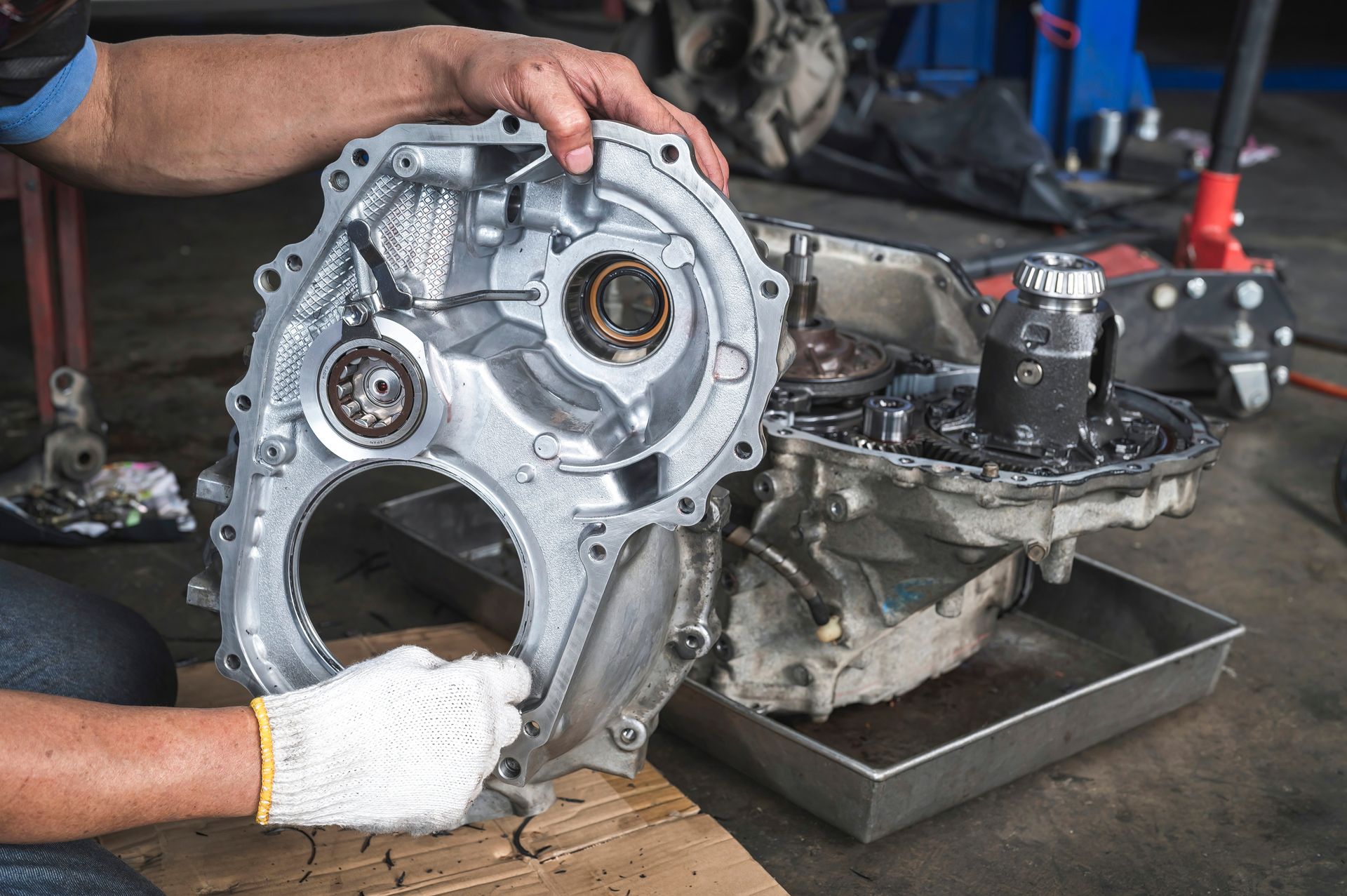 A man is working on a car engine in a garage.