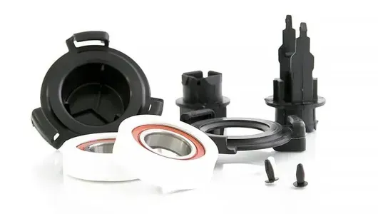 Black Plastic Parts and White Bearings — Cumming Airconditioning & Sheetmetal in Ryan, QLD