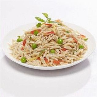 Plate of orzo pasta salad with peas and tomatoes.