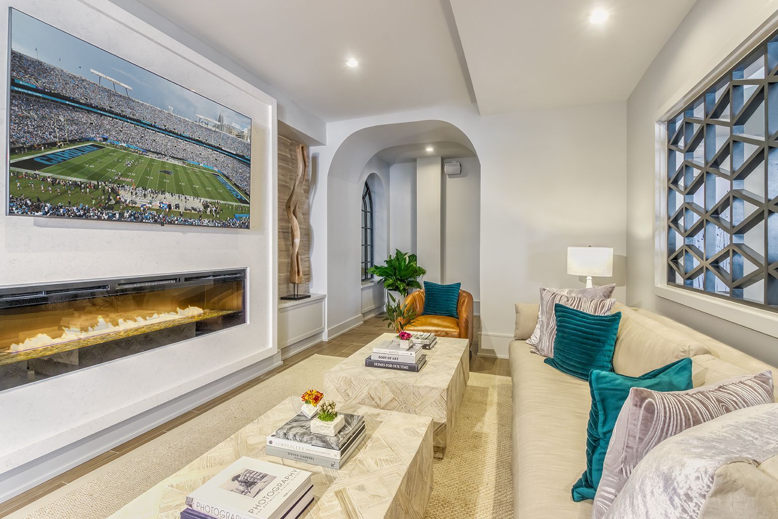 Art studio: long table with chairs, painting easels, sink, and watercolor wall decor.