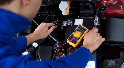 A mechanic completing diagnostic testing on a car