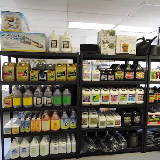 Shelves of various bottles of plant nutrients and growing supplies in a store.