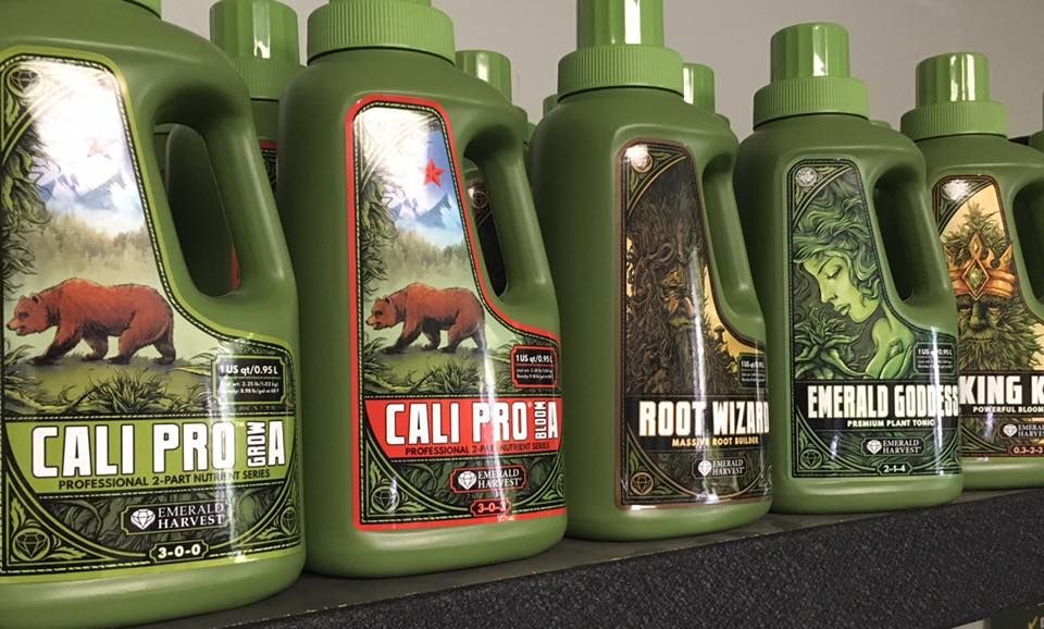 Green bottles of plant nutrients with labels featuring bears and foliage.