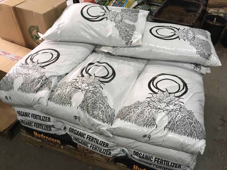 Woman in safety gear holding a wrench, looking concerned. Construction site background.