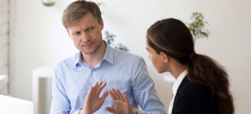 Manager discussing a workplace issue with an employee, representing a common leadership challenge.
