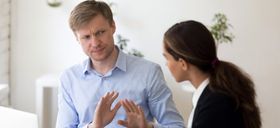 Manager discussing a workplace issue with an employee, representing a common leadership challenge.