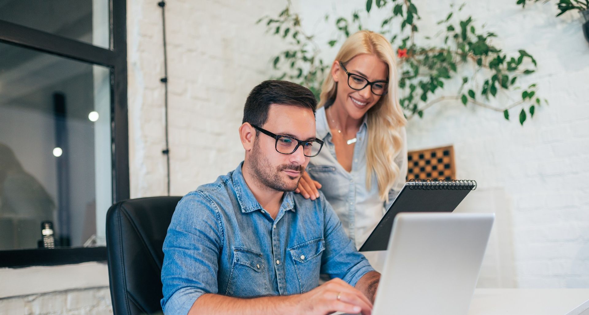 Two coworkers talking in an office, representing workplace relationships and HR guidelines