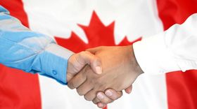Handshake in front of Canadian flag representing cross-border hiring