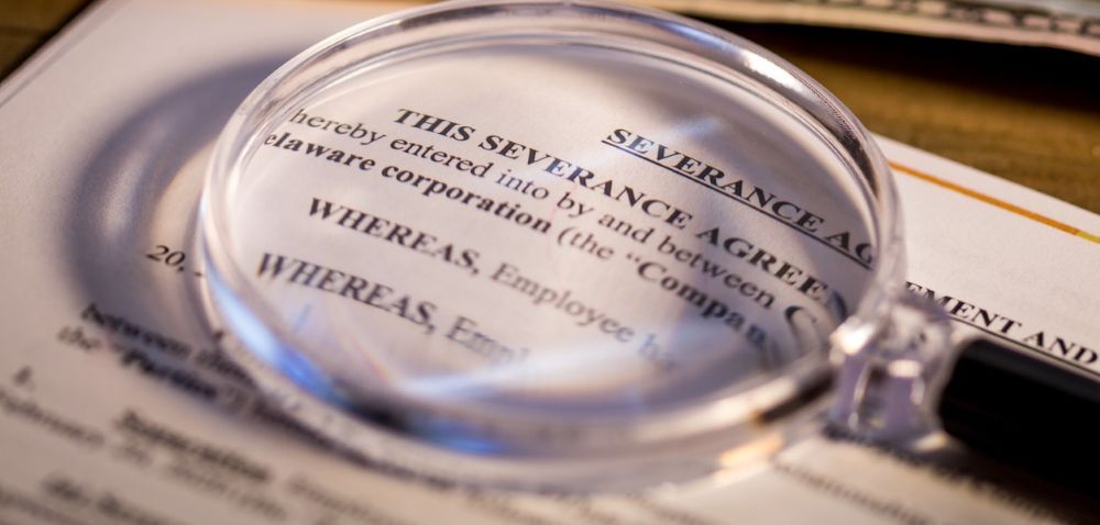 Magnifying glass on severance agreement