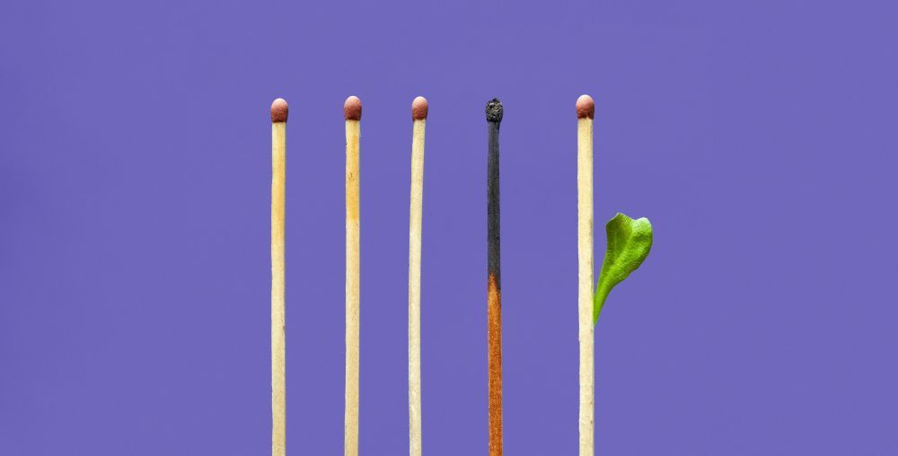 Burned-out match representing employee burnout in the workplace