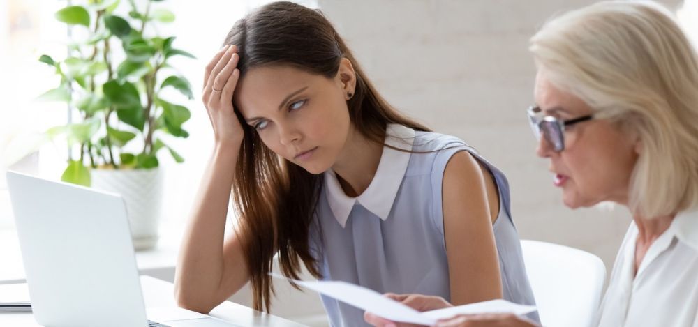 Manager and employee in a workplace discussion highlighting leadership challenges.