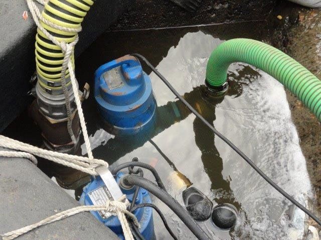 Closeup View of Two Hoses Connected to Blue Water Pump — Gretna, LA — Advanced Industrial Products