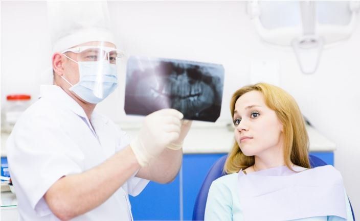 Dentist Showing X-ray To A Patient — San Diego, CA — San Diego Oral Maxillofacial