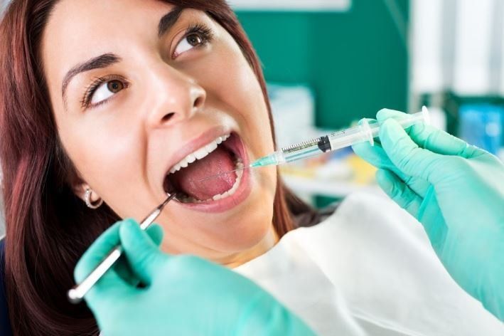 Woman Having Dental Assistance — San Diego, CA — San Diego Oral Maxillofacial