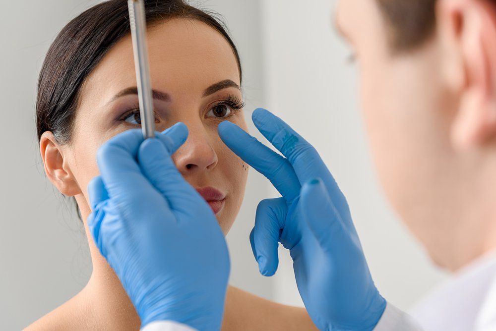 Cosmetic Facial Surgery — Doctor Examine the Patient's Face in San Diego, CA