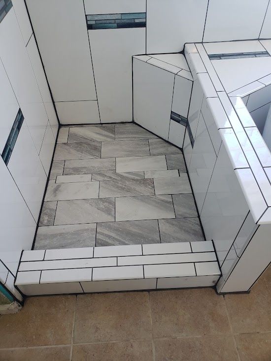 A bathroom with a walk in shower and a bathtub.