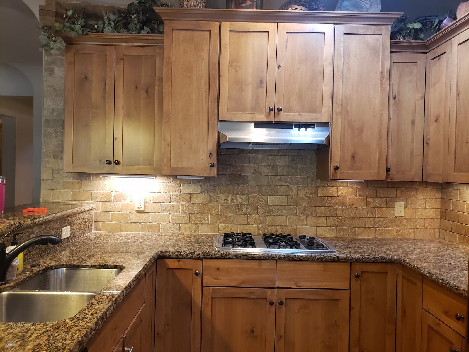 A kitchen with wooden cabinets and granite counter tops