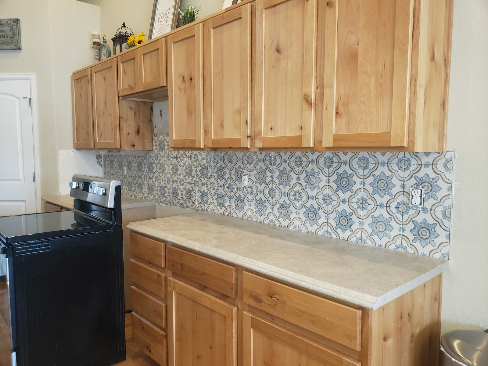 A kitchen with wooden cabinets and a black stove.