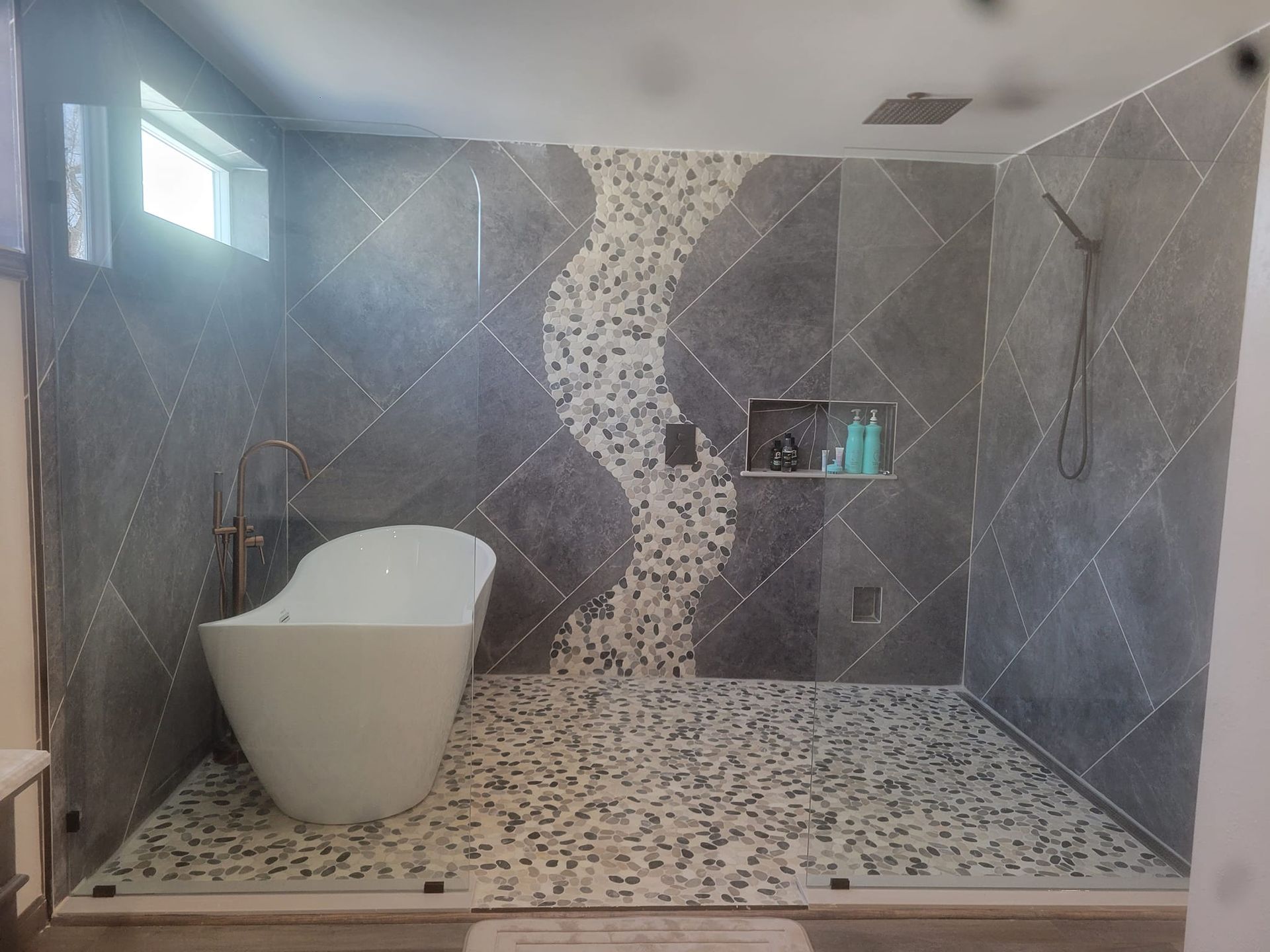 A bathroom with a bathtub and a walk in shower.