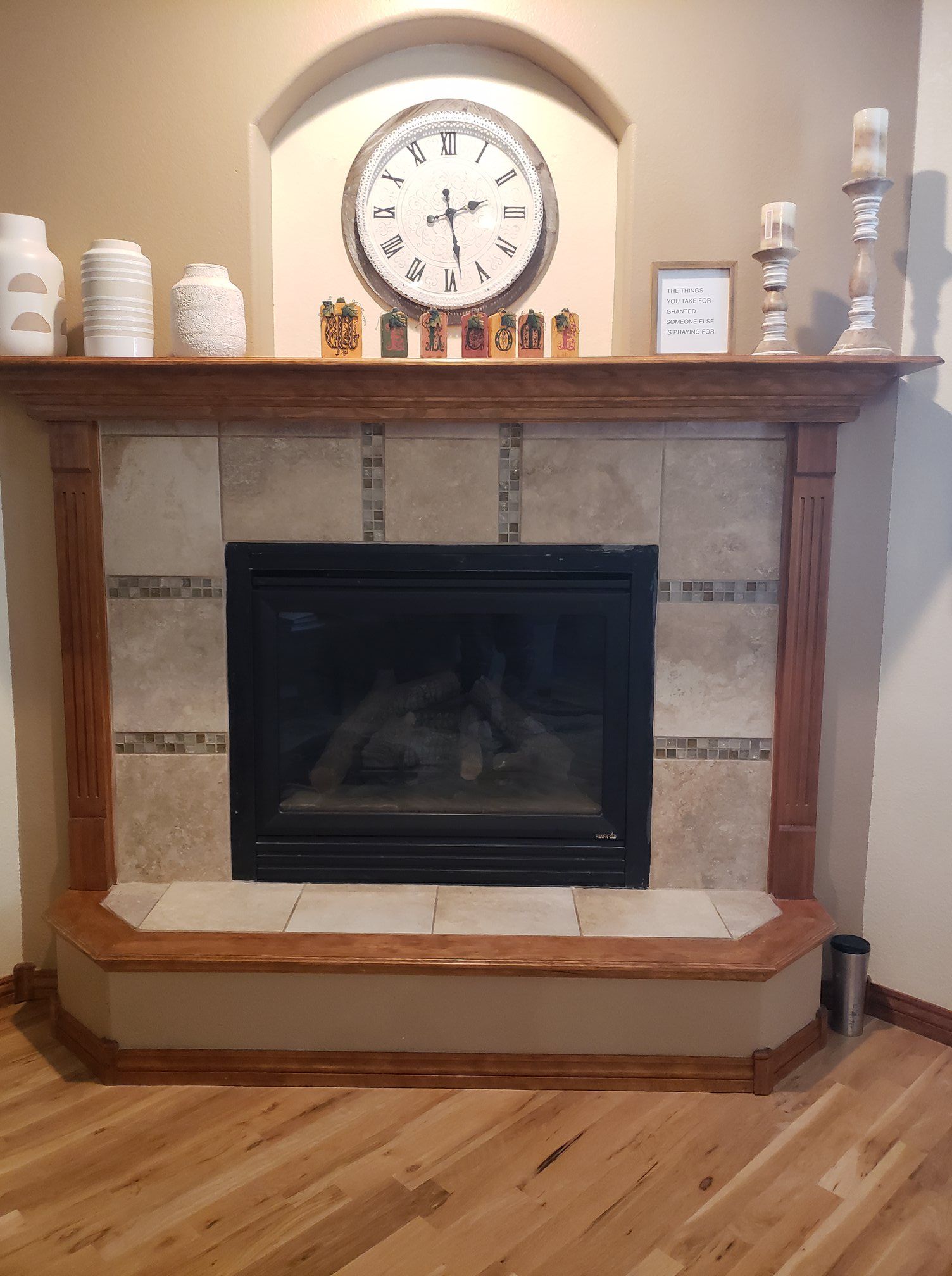 A fireplace with a clock above it in a living room