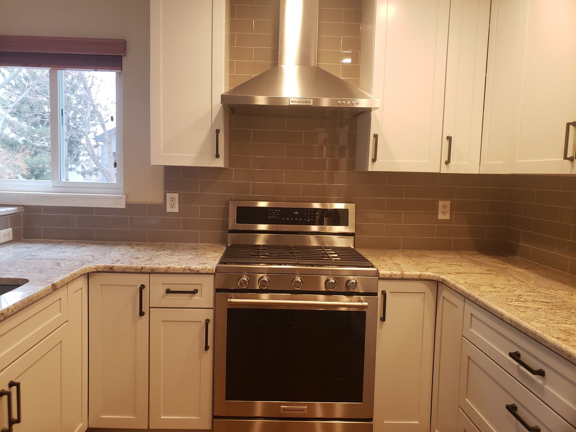 A kitchen with stainless steel appliances and white cabinets