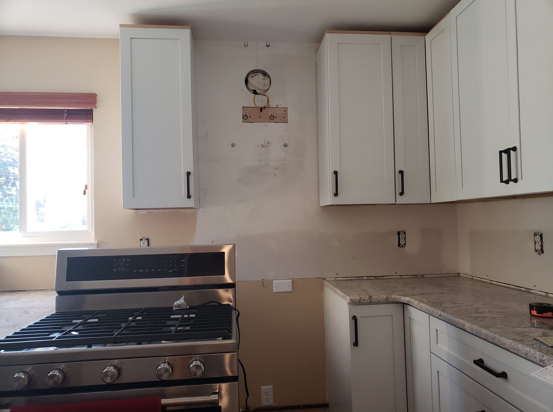 A kitchen with stainless steel appliances and white cabinets