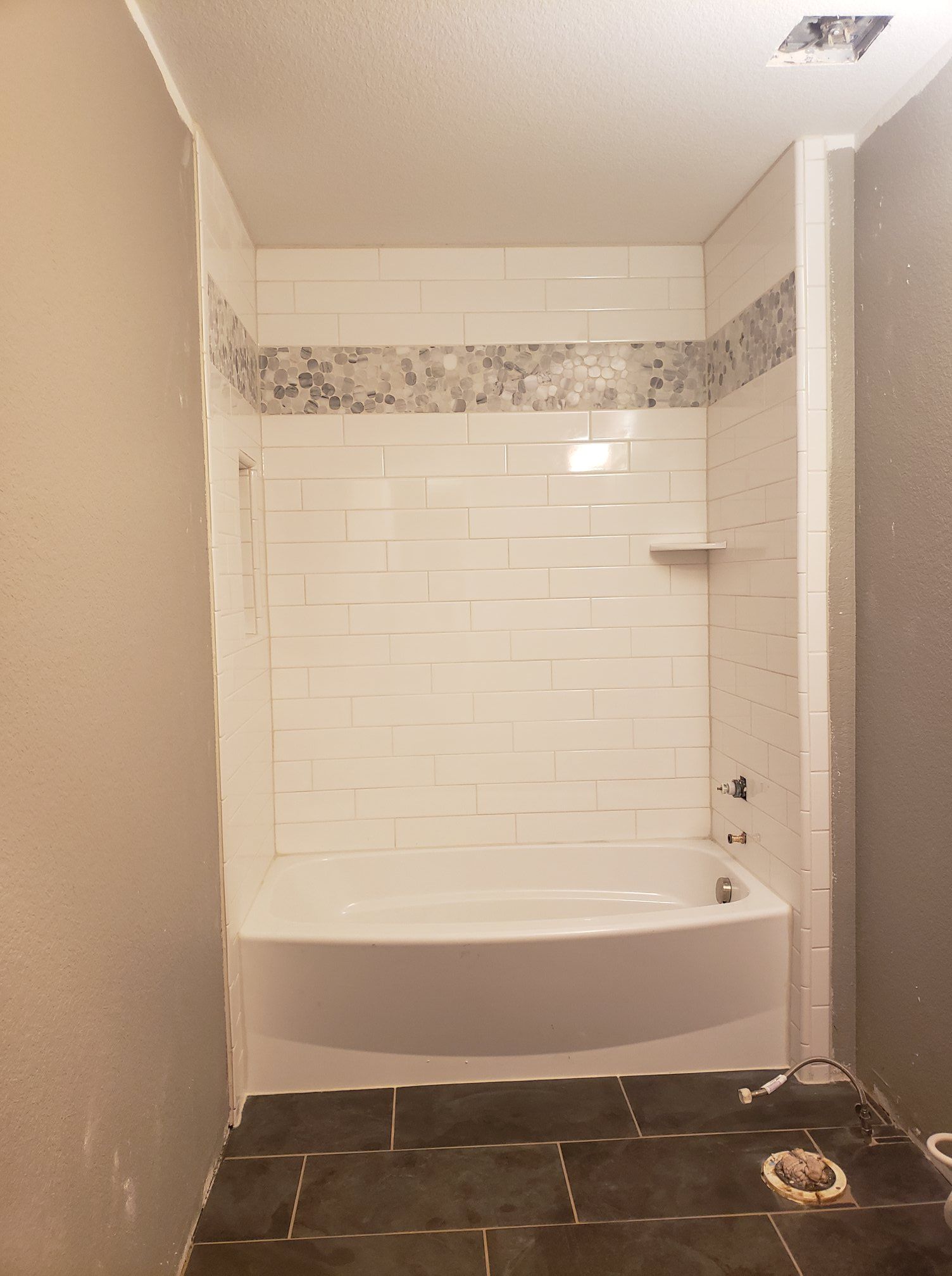 A bathroom with a bathtub and a shower.